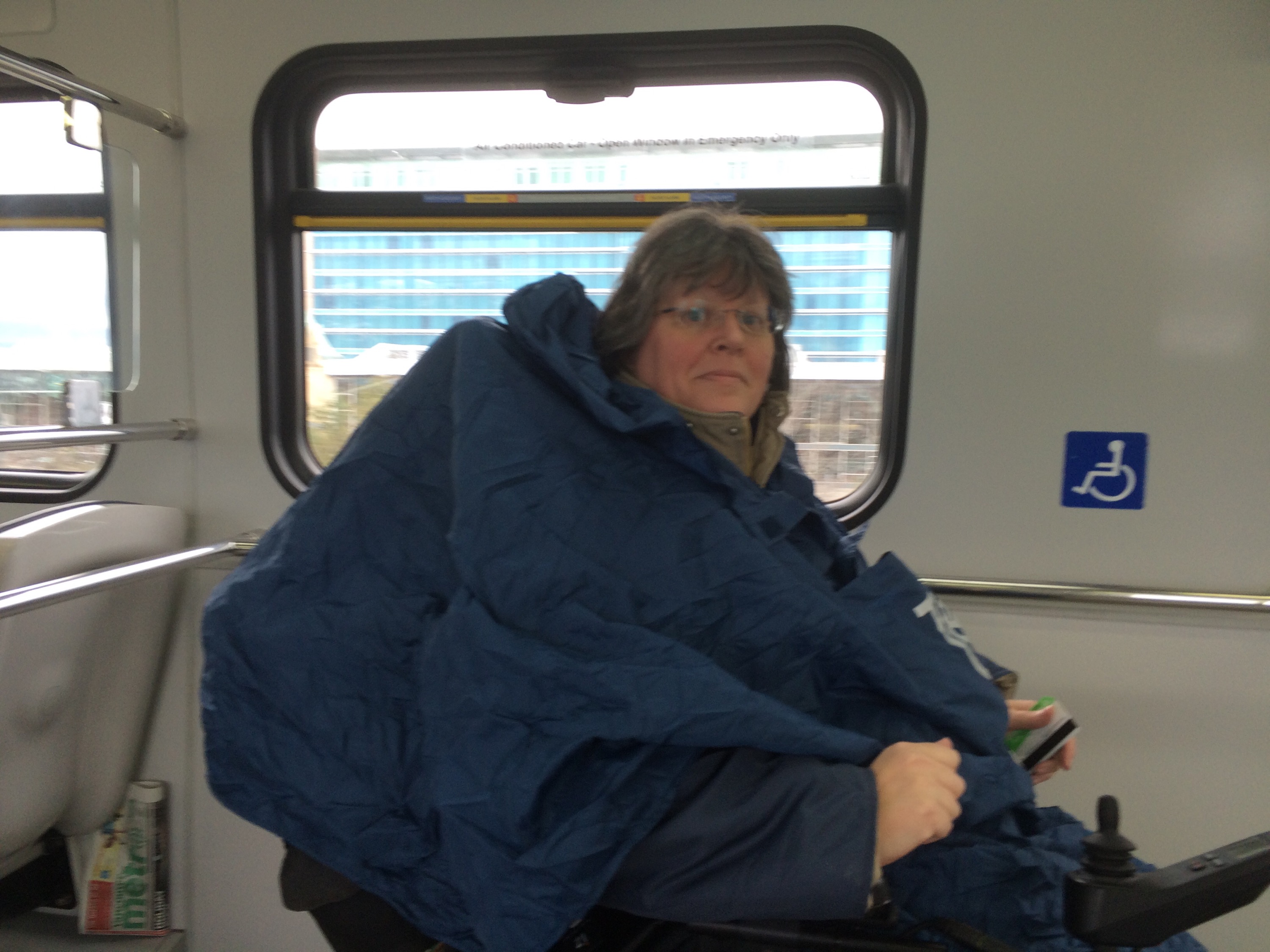 Me, on the SkyTrain with my massive rain poncho