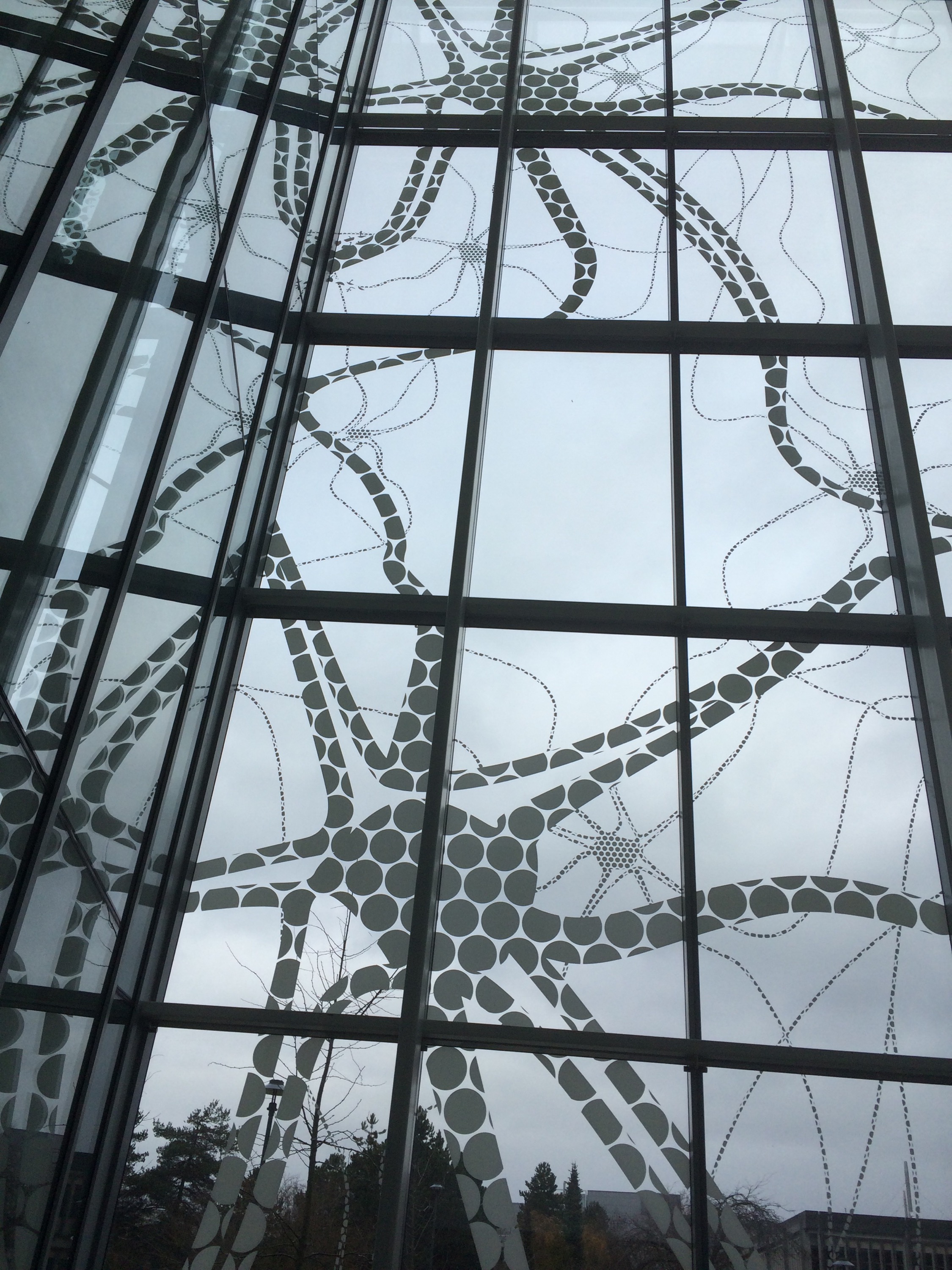 The windows at the building with a massive mural of brain cells