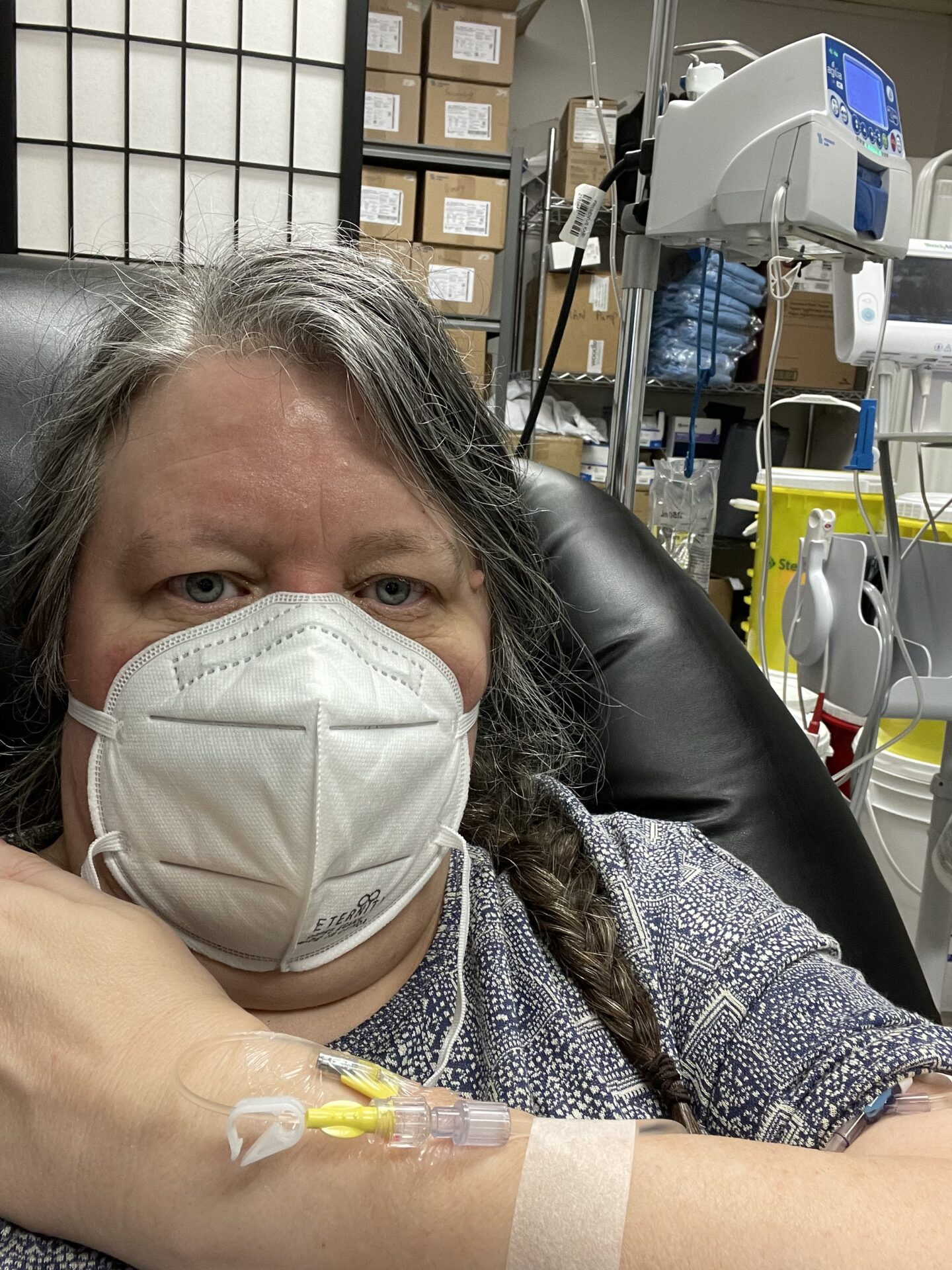 Me with mask on and IV in arm at infusion clinic