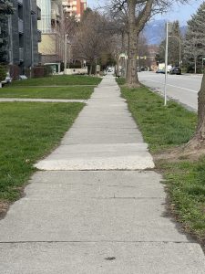A long stretch of very uneven sidewalk