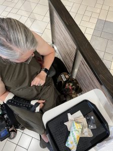 Leo lying next to Michelle, in the food court at the mall, training